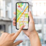Navigation App With Street Map Opened On Smartphone In Female Hands