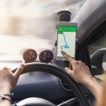 woman using gps navigation map on smartphone in car